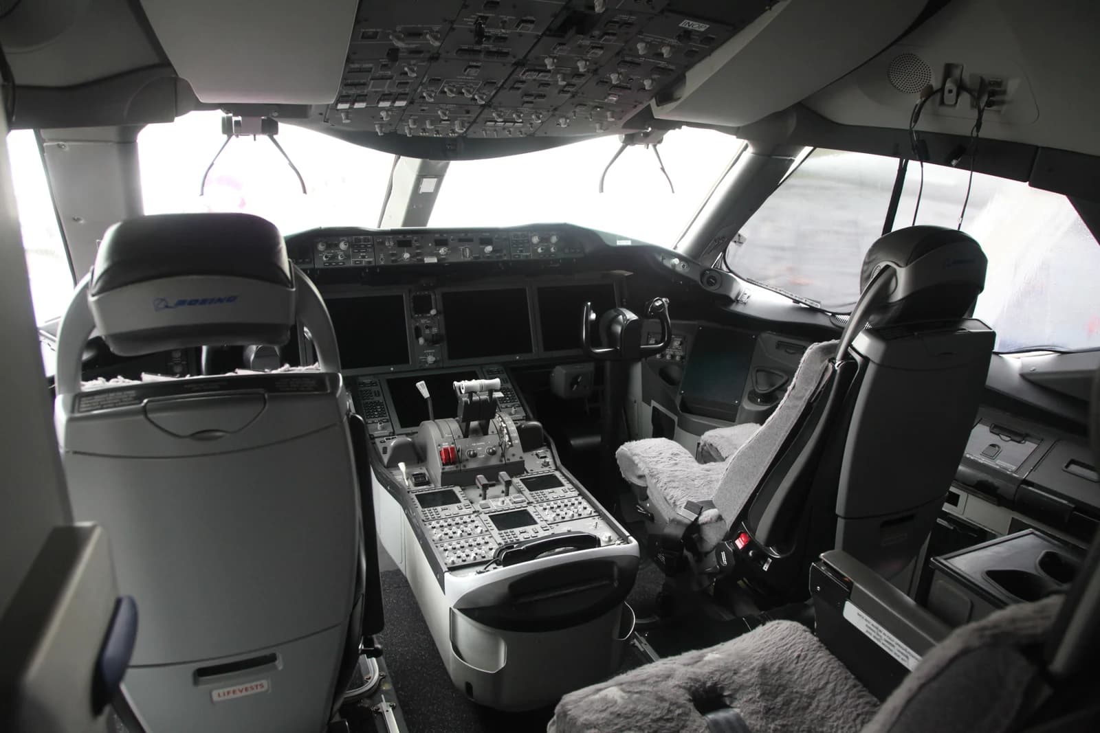 Boeing 787 flight deck with pilot seats, controls and instrument panels